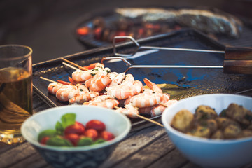 barbecue in the garden - summer- prawns and vegetables on skewers