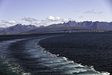 Ships wake leaving The Andøy Bridge in the strait between the islands of Andøya and Hinnøya in Nordland county, Norway.