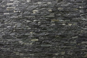 Серо чёрная каменная текстура из кирпичной стены частного дома