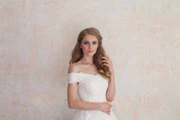 Fototapeta na wymiar a portrait of the bride before the wedding in white dress