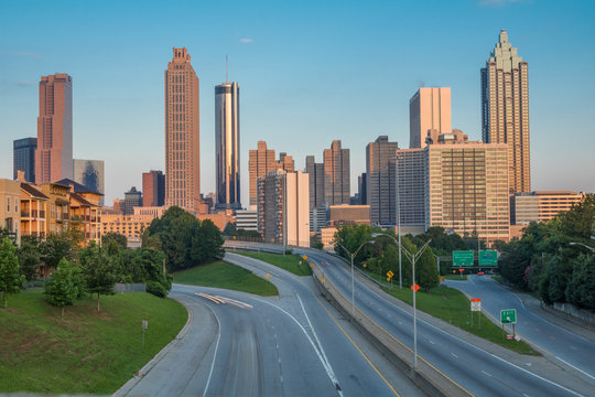 Horizontal photo of the Atlanta skyline as seen in the early morning from the Jackson Street Bridge (all business names on buildings have been edited out of the photo)
