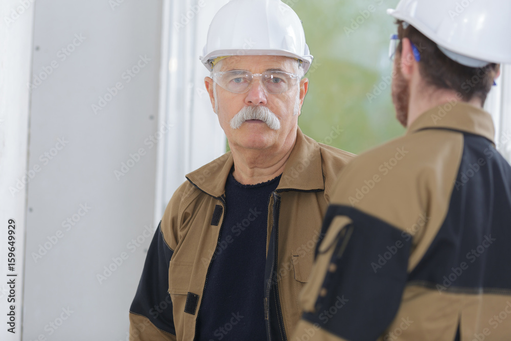 Wall mural two builders having a conversation