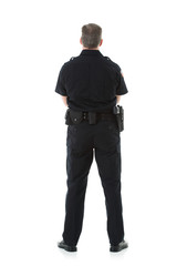 Fototapeta premium Police: Rear View Of Male Officer Standing Casually