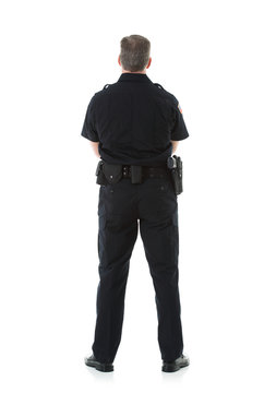 Police: Rear View Of Male Officer Standing Casually