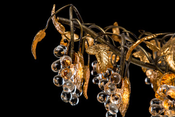 Classic chandelier in flower style isolated on black background. Close-up
