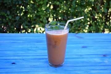 glass of apple, peach smoothie with straw on wooden table. Protein cocktail. Healthy drink. Fresh homemade smoothie. Healthy breakfast of smoothie