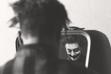 clown smiling in front of mirror