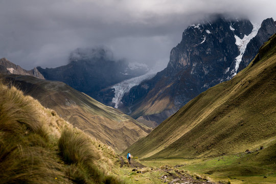 Man walking in the valley of mountain range