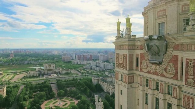 Aerial shot. Flight near the building of Moscow State University. View from the top of the territory of Moscow State University, buildings, yards, infrastructure. Blue clear sky, good summer weather