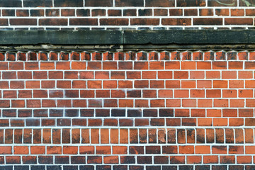 A wall made of bricks with white interstice