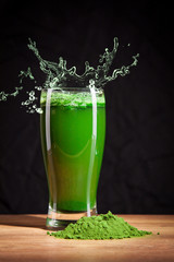 Young barley and chlorella spirulina, water splash. Detox superfood.