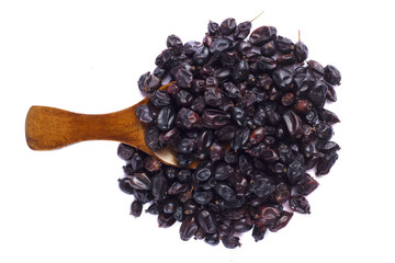 Dried barberry in spoon on white background