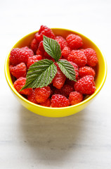 Sweet raspberries in bowl on table. Close up, top view, high res