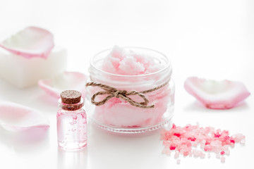 homemade spa with rose cosmetic set, cream, salt and oil on white background