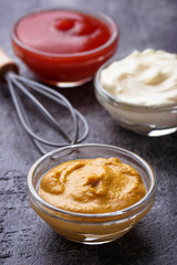 Set of different sauces: mustard, ketchup, mayonnaise.