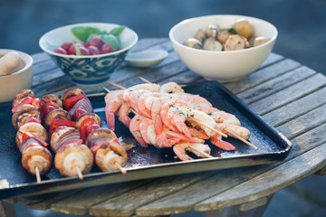 barbecue in the garden - summer- prawns and vegetables on skewers