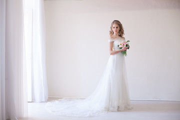Fototapeta premium bride in wedding dress holding a bouquet of flowers