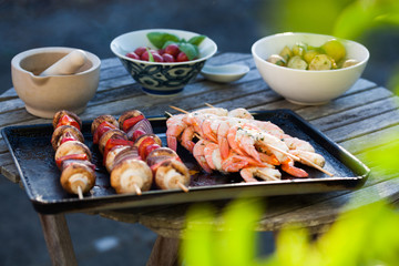 barbecue in the garden - summer- prawns and vegetables on skewers