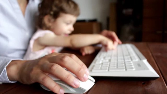 child disturbing keyboard typing