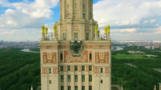 Vertical Takeoff of the Drone Main building of the Moscow State University with a spire, aerial shot. In the background a stunning view from above of Moscow, blue sky, green trees, good summer weather