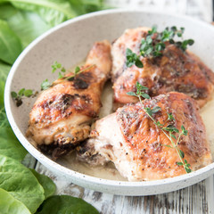 Fried golden chicken thighs with spices and herbs. Baked chicken legs