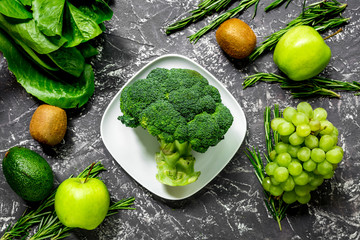 organic food for homemade salad with green vegetables on dark desk background top view