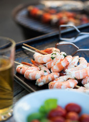 barbecue in the garden - summer- prawns and vegetables on skewers