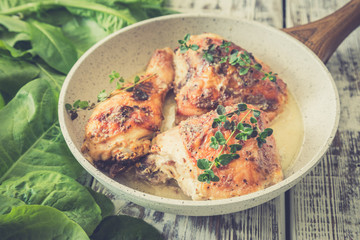 Fried golden chicken thighs with spices and herbs. Baked chicken legs