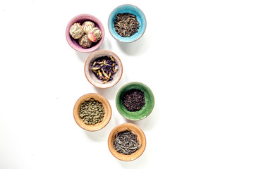 Tea-party with different herbal tea on white desk background flat lay mock up