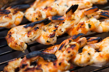 barbecue in the garden - summer- prawns and vegetables on skewers