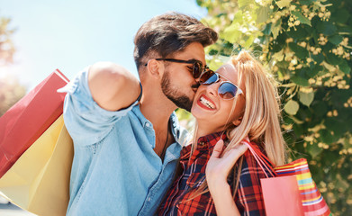 Fototapeta premium Shopping time. Young couple in shopping. Consumerism, love, dating, lifestyle concept