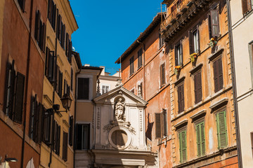 Obraz premium old church in-between of houses at rome