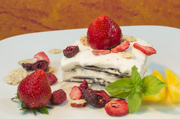 A chocolate and cream ice cream with red berries
