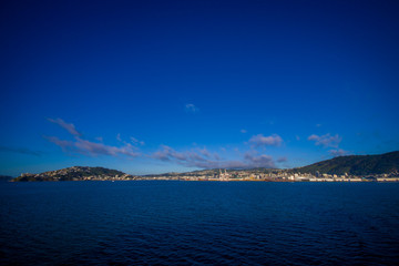 Beautiful view of the city in the horizont from ferry between north and south island in New Zealand, sailing into Picton
