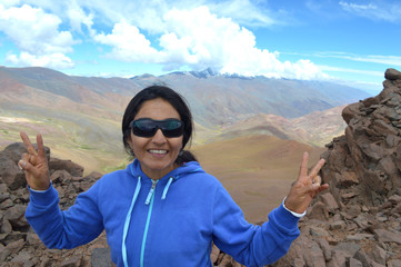 Young woman poses happy on the heights of Acay, Salta, Argentina