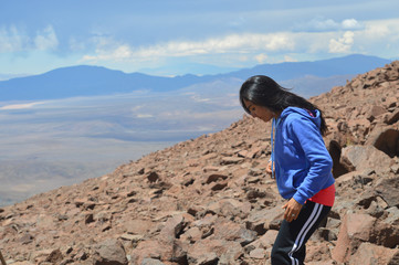Fototapeta premium Young woman explores the heights of Acay in Salta, Argentina