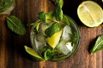 mojito cocktail with rum, lime and soda, garnished with mint