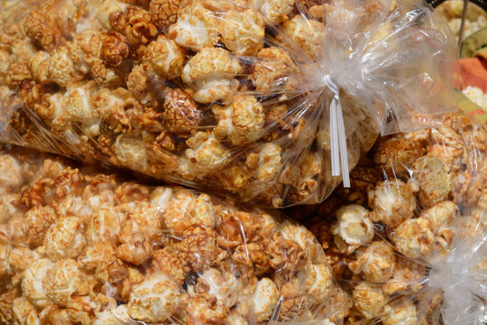 Spicy caramel covered kettle corn popcorn in large bags at farmer's market