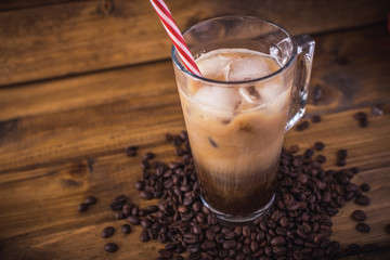 iced coffee on rustic wooden background.
