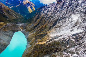 SOUTH ISLAND, NEW ZEALAND- MAY 25, 2017: Beautiful landscape and turquoise lagoon, mighty mountains covered by snow behind, South Island in New Zealand