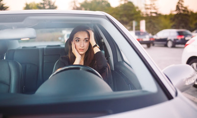 The girl in the car is in a traffic jam.