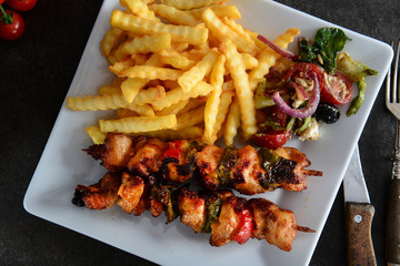 Skewers with fries and salad