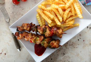 Skewers with fries and salad