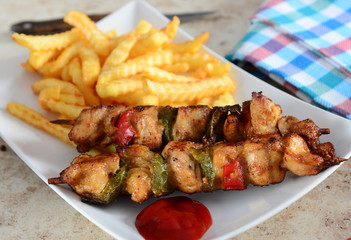 Skewers with fries and salad