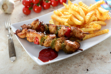 Skewers with fries and salad