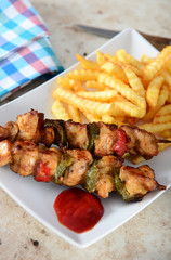 Skewers with fries and salad