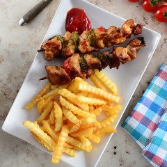 Skewers with fries and salad