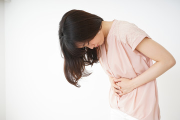 Obraz premium Young woman suffering from a stomachache