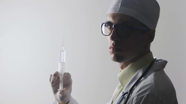 Portrait of a doctor with a syringe. An injection