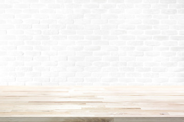 Wood table top on white brick wall background
